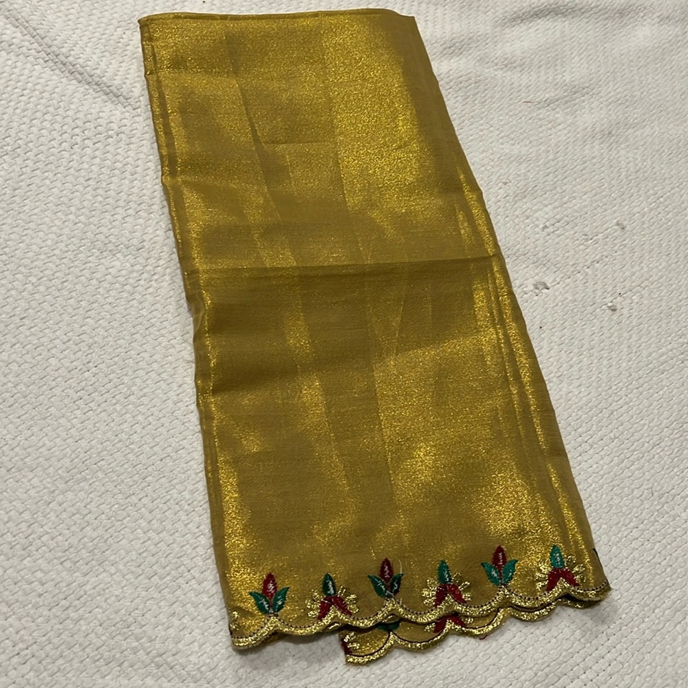 Shimmery gold fabric square with scalloped embroidered lining